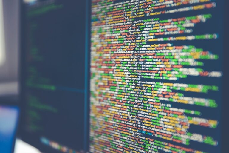 Close-up view of colorful programming code on a computer screen, showcasing technology and advancements in AI