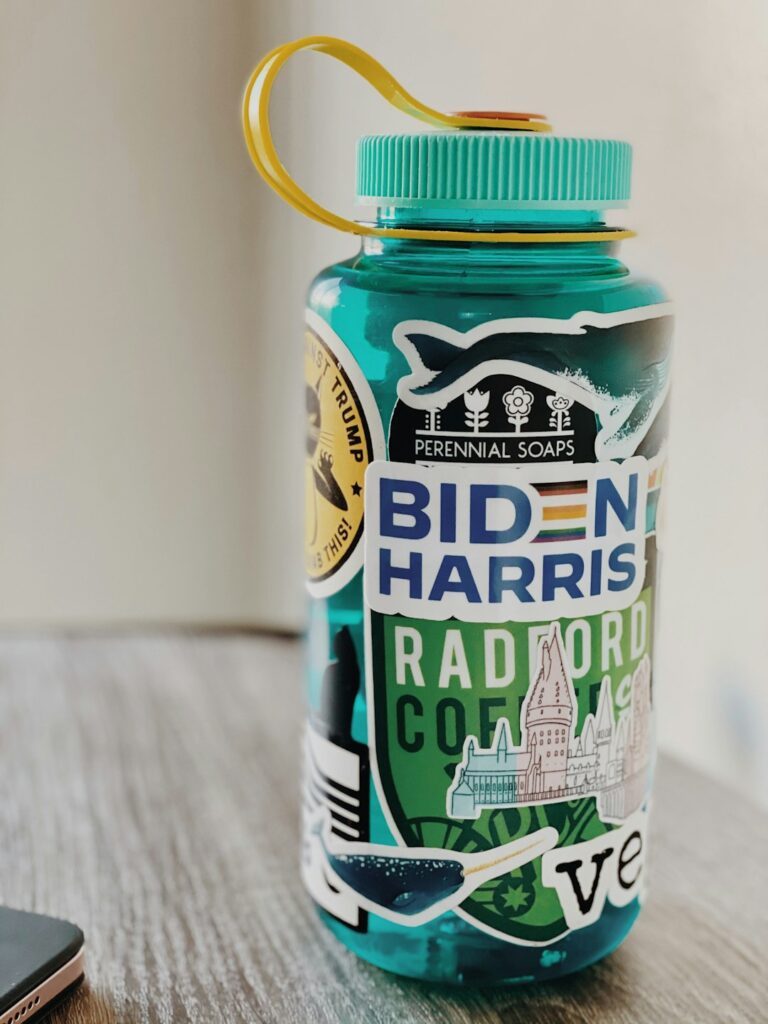 Water bottle with Biden-Harris sticker on a table