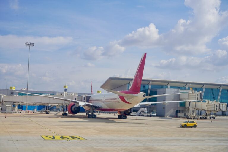 Boeing airplane parked at the airport with passenger boarding bridge attached