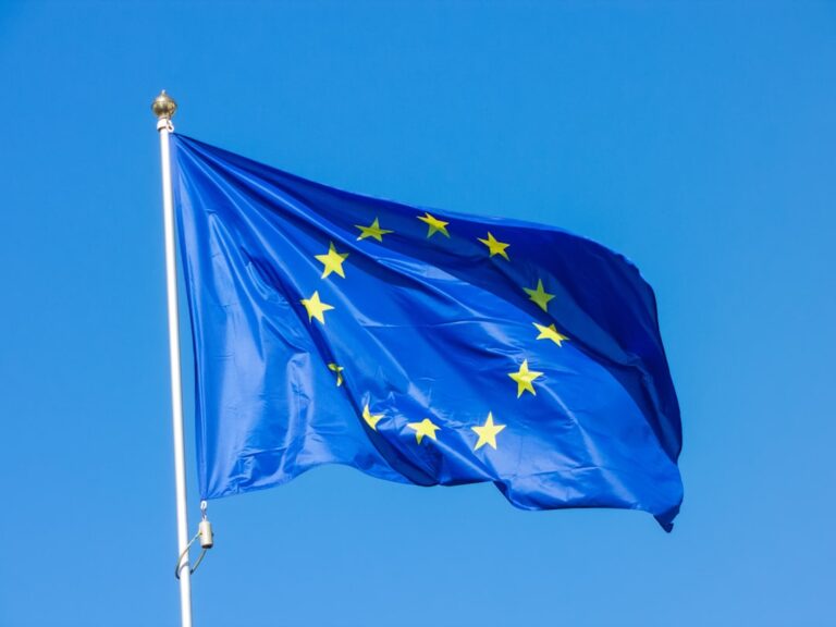 European Union flag waving in the wind against a clear blue sky