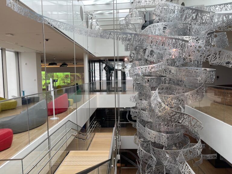 Modern office interior with abstract metal sculpture and open space design