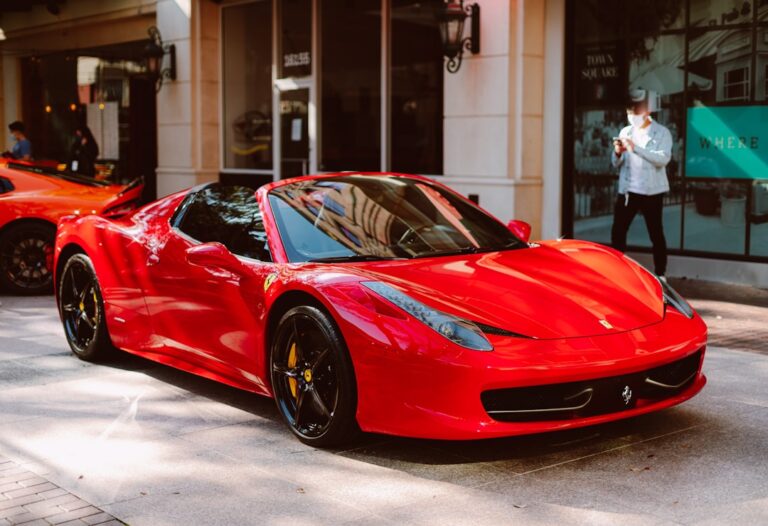 Red Ferrari sports car parked on a stylish street