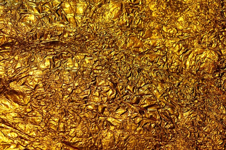 Close-up of crumpled gold foil representing gold's stability in volatile markets