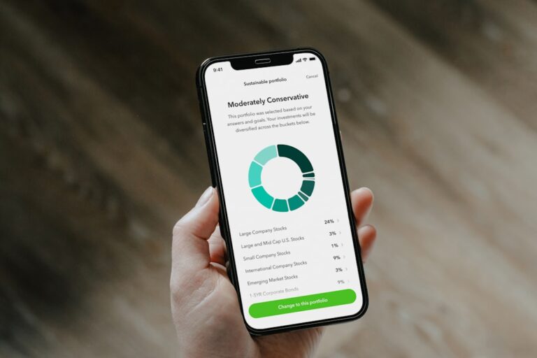 Inflation Spooks the Market, But Smart Investors See Opportunity Close-up of a hand holding a smartphone showing a moderately conservative investment portfolio