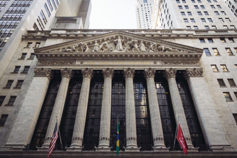 Facade of the New York Stock Exchange building with American and other flags