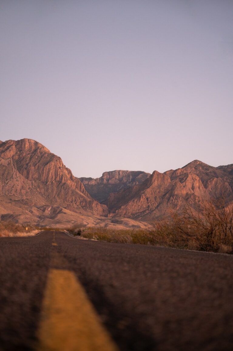 Road leading to rocky hills in the Texas desert during dawn