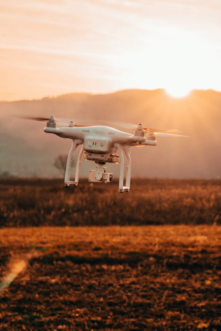 Agriculture drone flying over a field at sunset