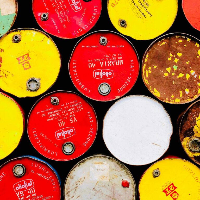 Top view of colorful oil drums representing changes in oil prices and market dynamics