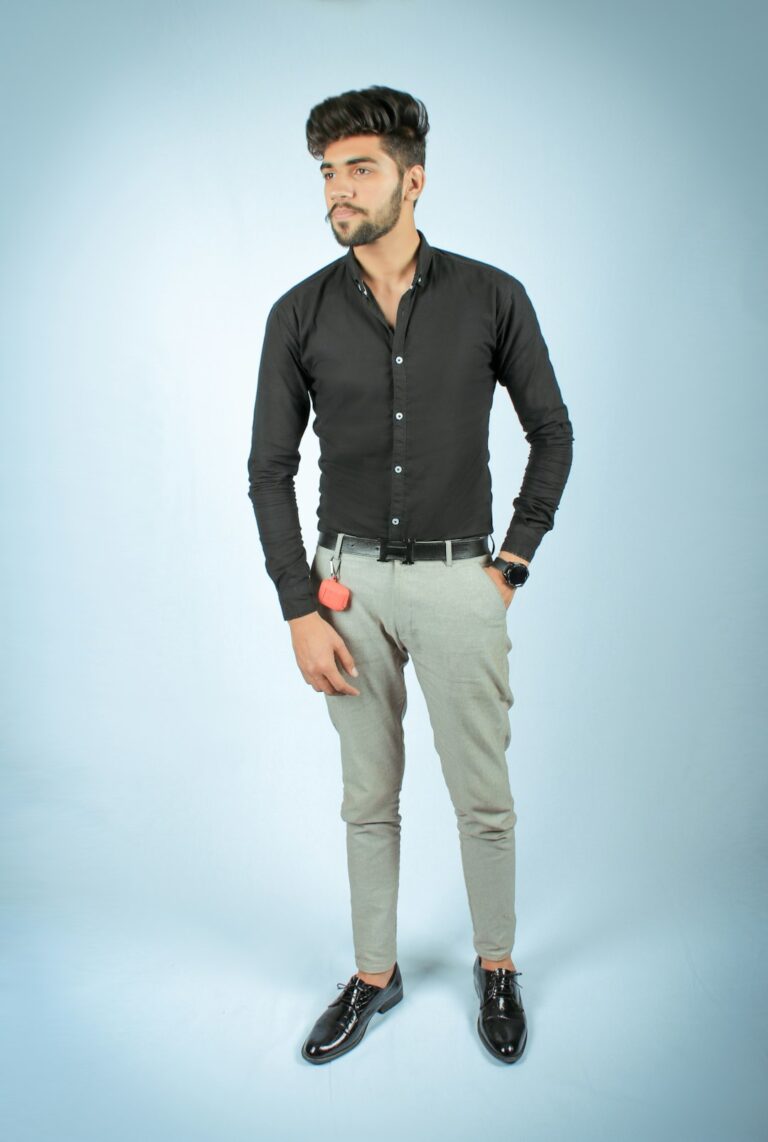 Confident young man standing in a relaxed pose, symbolizing eager investors responding to Best Buy's record earnings report.