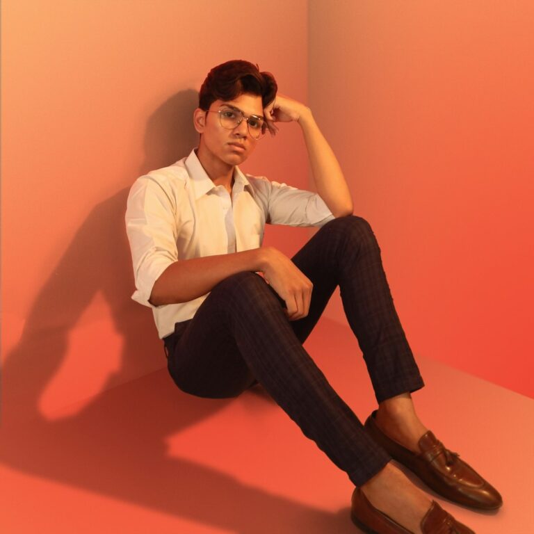 Person sitting in a stylish pose, reflecting strategy and confidence