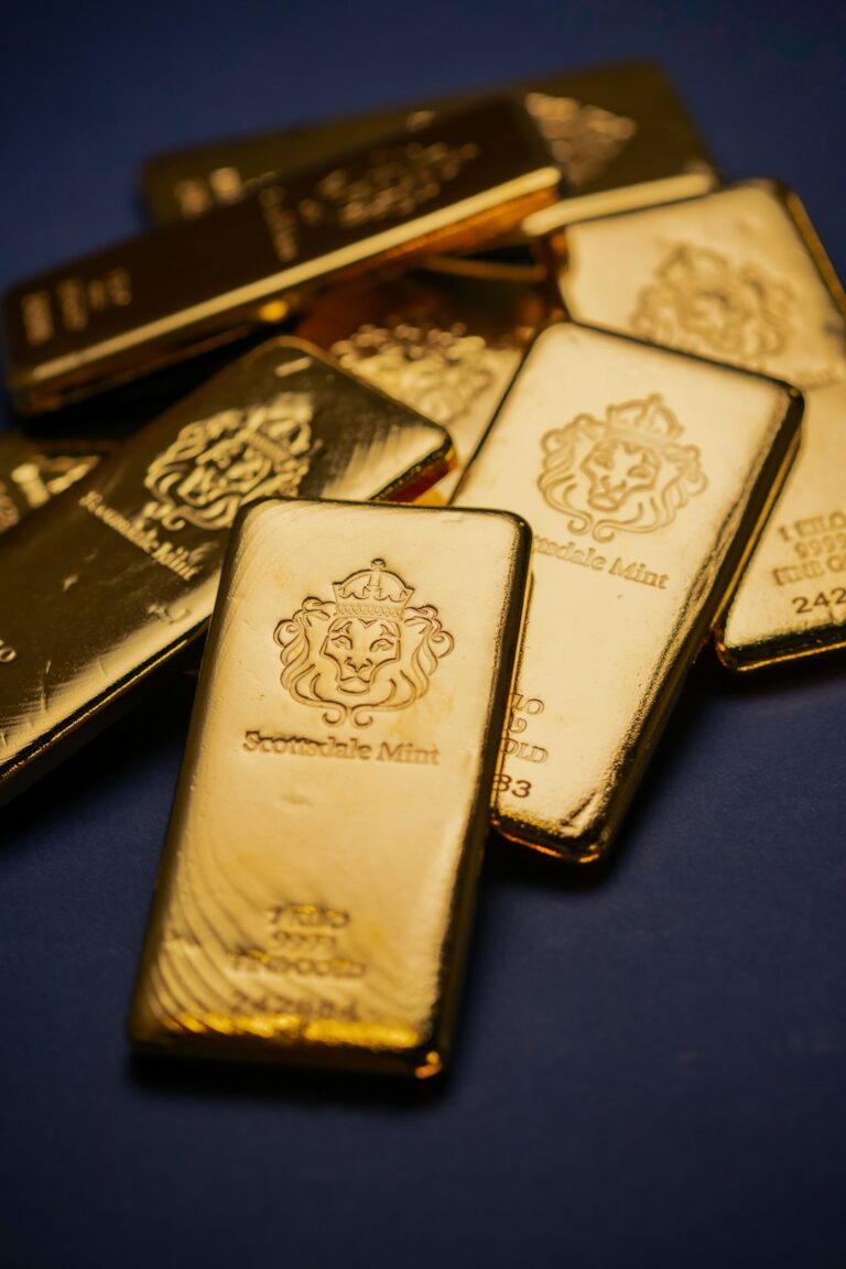 Gold bars from Scottsdale Mint placed on a dark surface