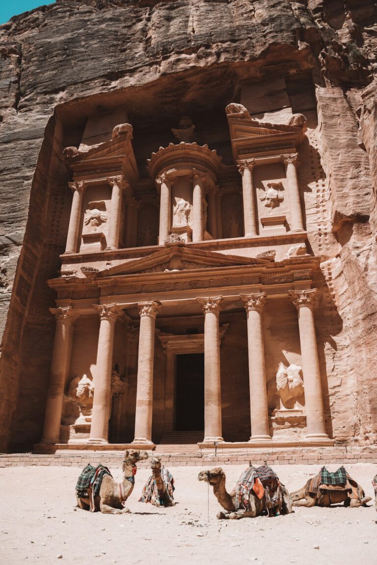 The ancient Treasury of Petra with camels resting in front