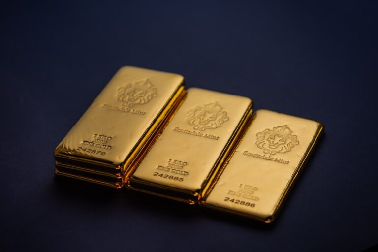 Stacks of gold bars on a dark background, representing wealth and investment