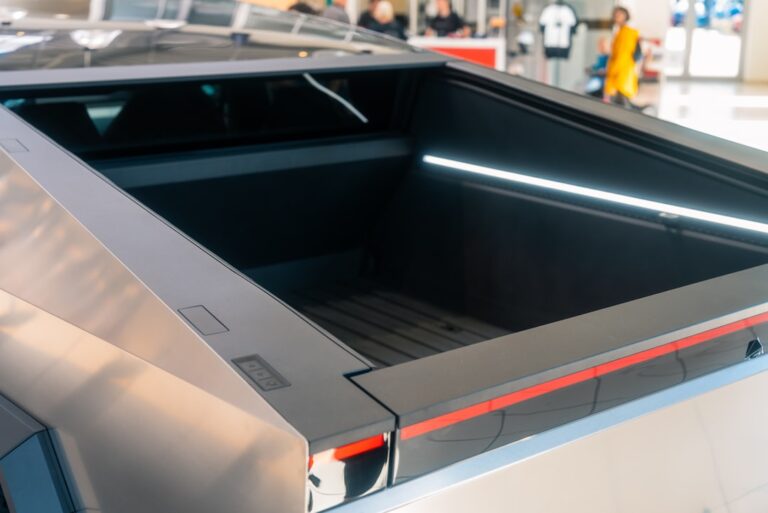 Close-up view of Tesla Cybertruck's bed area in a showroom setting